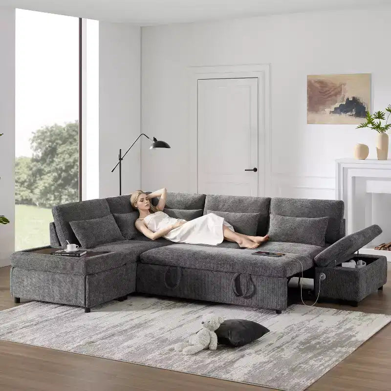 Divano sezionale estraibile a L beige/grigio con pouf contenitore e bracciolo di ricarica, 6 posti